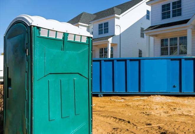 a row of porta potties at a busy job site